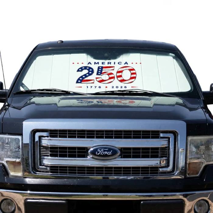 Covercraft America 250 sunshield installed inside a car windshield, held in place by the sun visors.