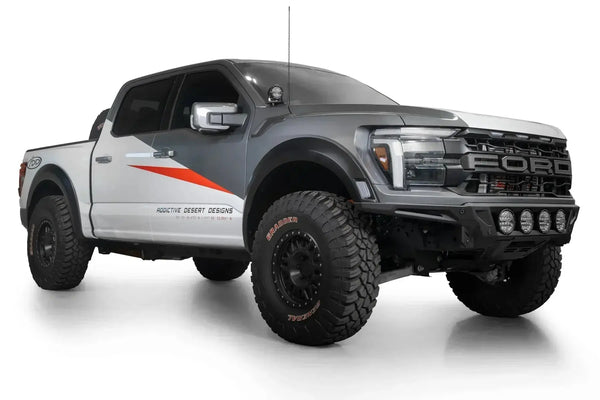 Truck with Addictive Desert Designs Hammer Black front bumper in off-road desert setting.