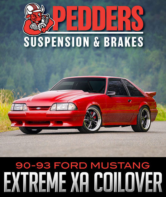 Pedders eXtreme XA Adjustable Coilover Kit for 1990–1993 Ford Mustang Fox Body, featuring gas-pressurized mono-tube body, camber/caster plates, and 32-position damping adjustment.