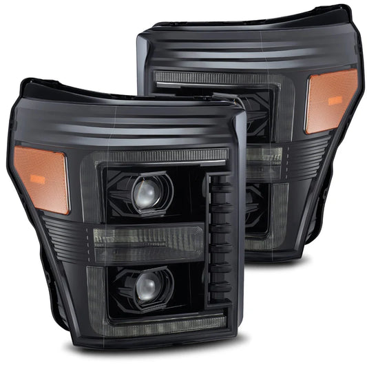 Pair of black car headlights with orange accents on a white background