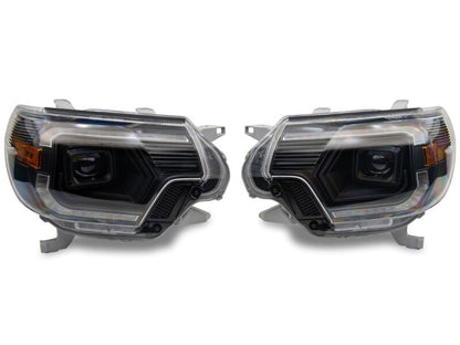 Raxiom 12-15 ToyotaTacoma Axial Series Switchback Projector Headlights- Black Housing- Clear Lens