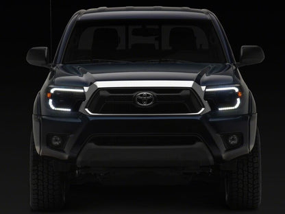 Raxiom 12-15 ToyotaTacoma Axial Series Switchback Projector Headlights- Black Housing- Clear Lens