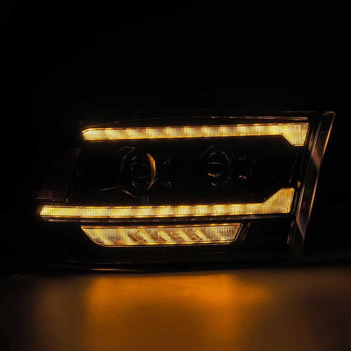 AlphaRex 880560 Ram projector headlights with full amber activation light illuminated