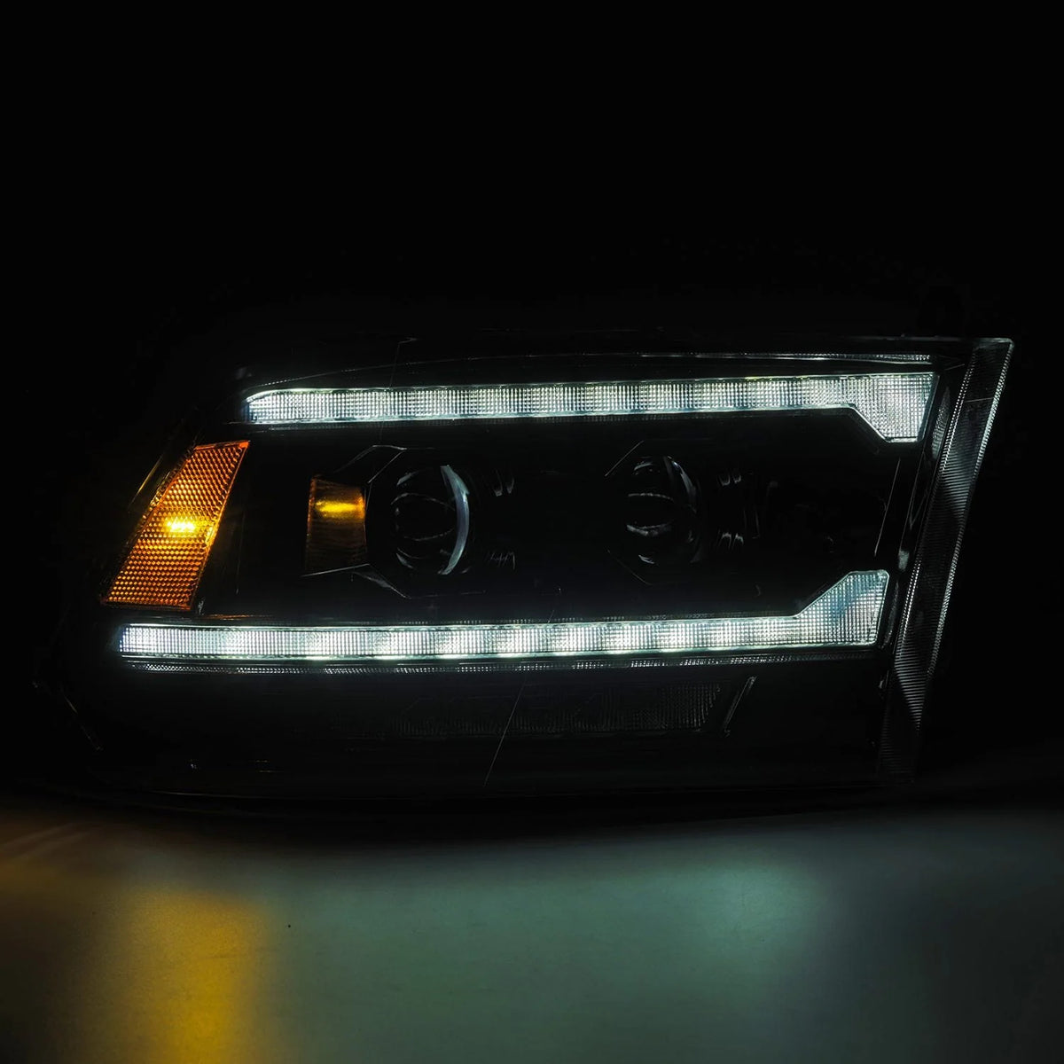 AlphaRex 880560 Ram LUXX LED headlights displaying amber sequential turn signal function