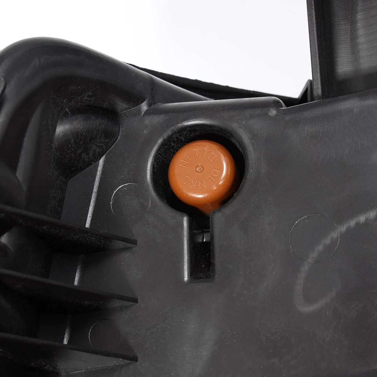 Headlight beam level adjustment screw knob and moisture breather cap detail on AlphaRex 880615