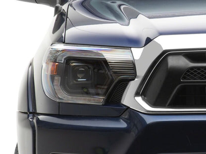 Raxiom 12-15 ToyotaTacoma Axial Series Switchback Projector Headlights- Black Housing- Clear Lens