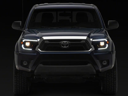 Raxiom 12-15 ToyotaTacoma Axial Series Switchback Projector Headlights- Black Housing- Clear Lens