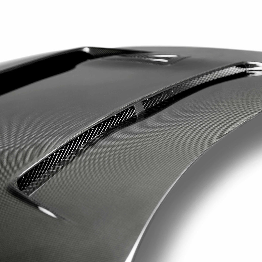 Overhead view of the Seibon DV-Style Carbon Fiber Hood installed on a Nissan GT-R, displaying the vent layout for optimized engine cooling and airflow.