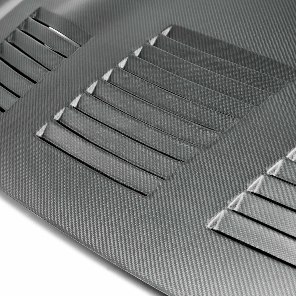 Close-up of the vented design on the Seibon GT-Style Dry Carbon Hood, highlighting its dry carbon fiber weave and premium finish.