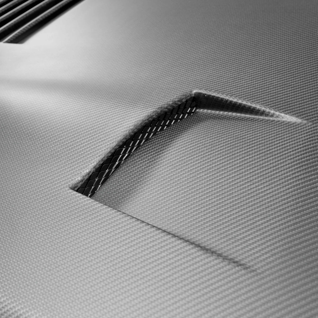 Overhead shot of the Seibon GT-Style Dry Carbon Hood on a GT-R, displaying the functional vent layout for improved cooling and airflow.