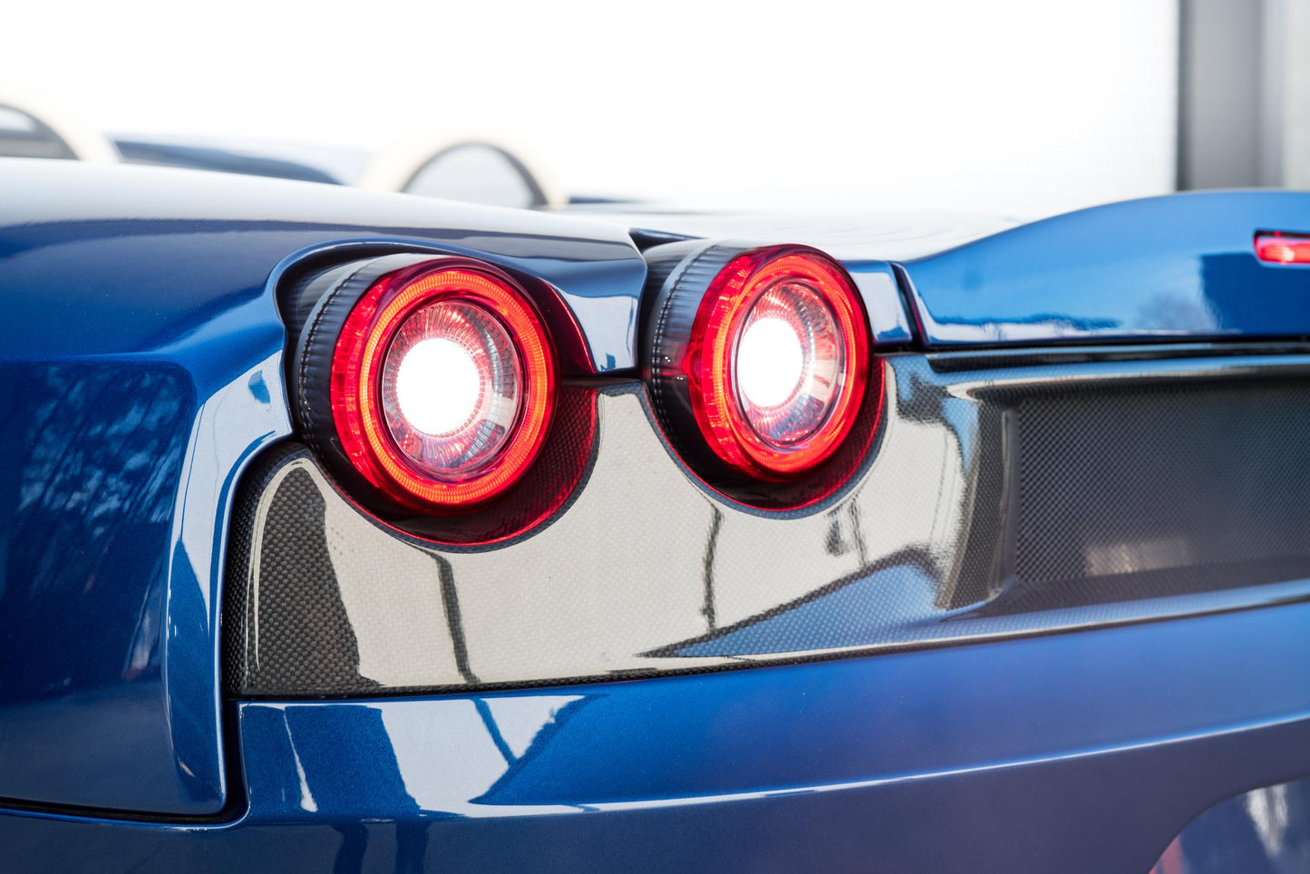 Morimoto LF357 smoked XB LED tail lights for 2005-2010 Ferrari F430 installed showing reverse lights