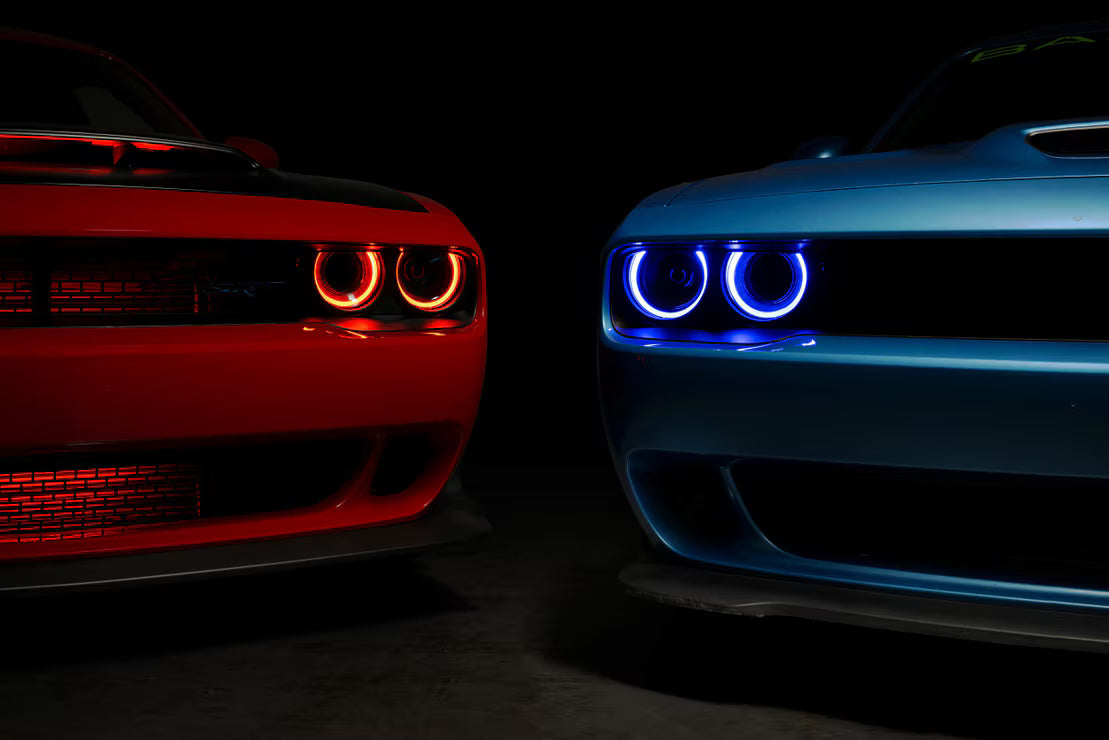 Morimoto XRGB LF495 headlights installed on Dodge Challenger with blue RGB DRLs front three-quarter view
