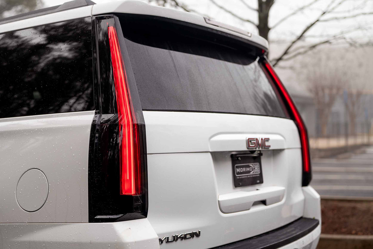 Morimoto LF766 smoked LED tail lights for 2015-2020 GMC Yukon with sequential turn signals shown installed side angle