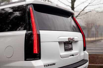Morimoto LF766 smoked LED tail lights for 2015-2020 GMC Yukon with sequential turn signals shown installed side angle