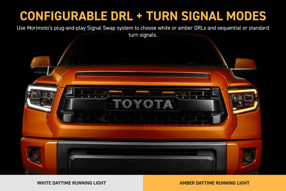 Orange Toyota truck with daytime running lights on a black background