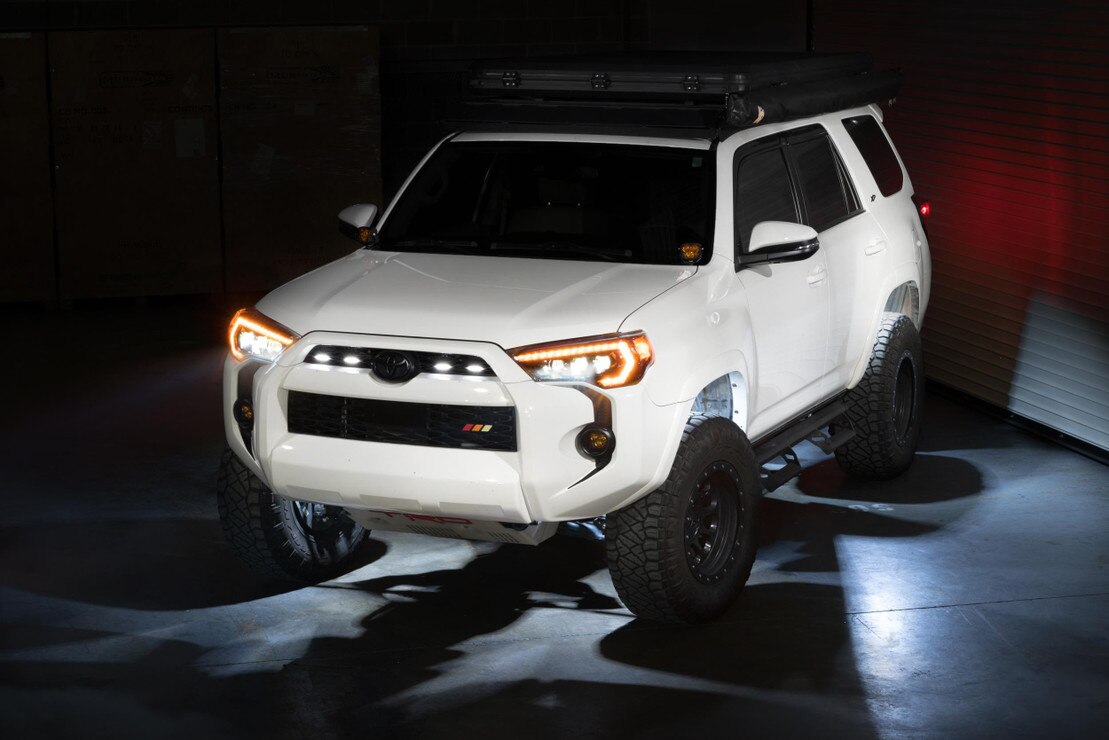 Morimoto XRL05 V2 white LED rock light kit 4 piece universal for trucks jeeps SUVs shown installed on Toyota Tacoma