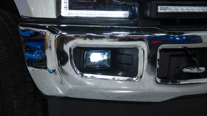 Close-up of a vehicle's chrome bumper and headlight