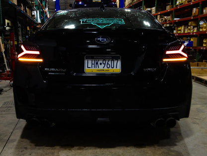 Black Subaru car with illuminated taillights in a warehouse setting