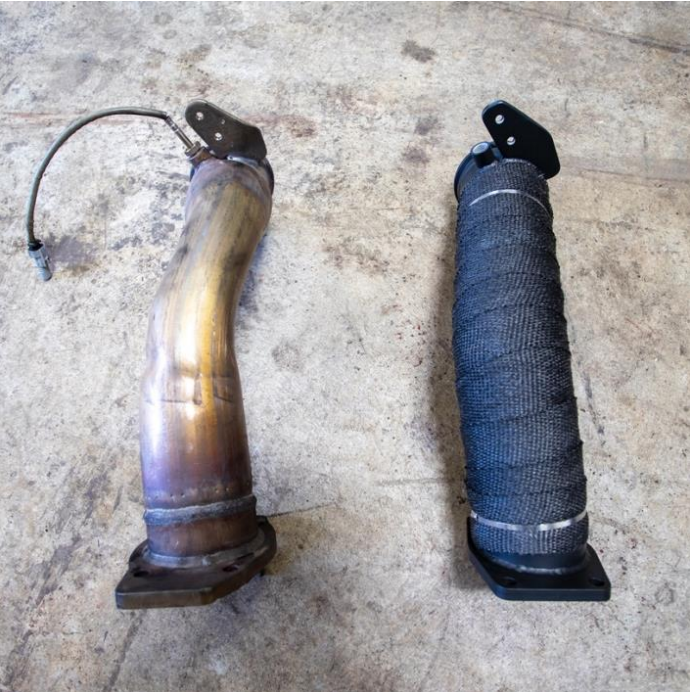 Wehrli WCF100129 3.5 inch downpipe black ceramic coated L5P Duramax heat wrapped image compares wehrli downpipe to the OEM down pipe