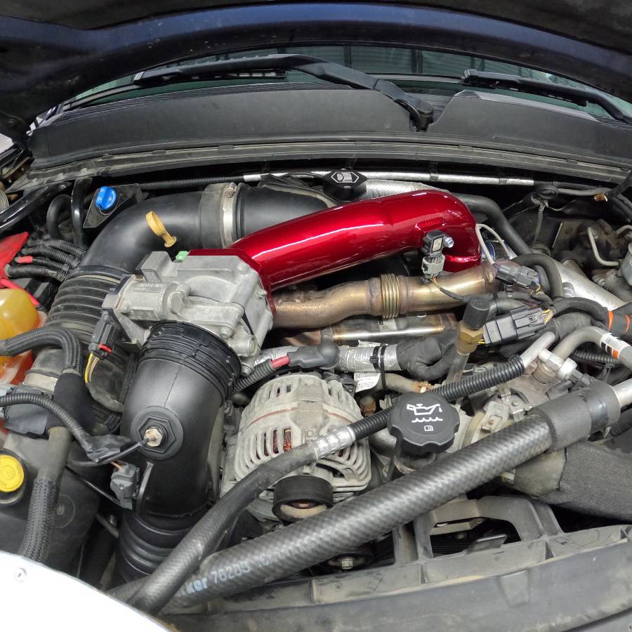 Wehrli WCF100328-GB 3 inch passenger upper intercooler crossover pipe gloss black LML Duramax installed on truck