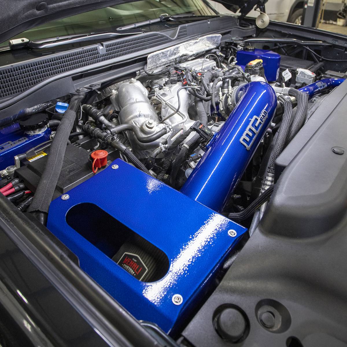 Wehrli WCF100344-RED 4 inch cold air intake kit with air box red L5P Duramax installed on truck in blue