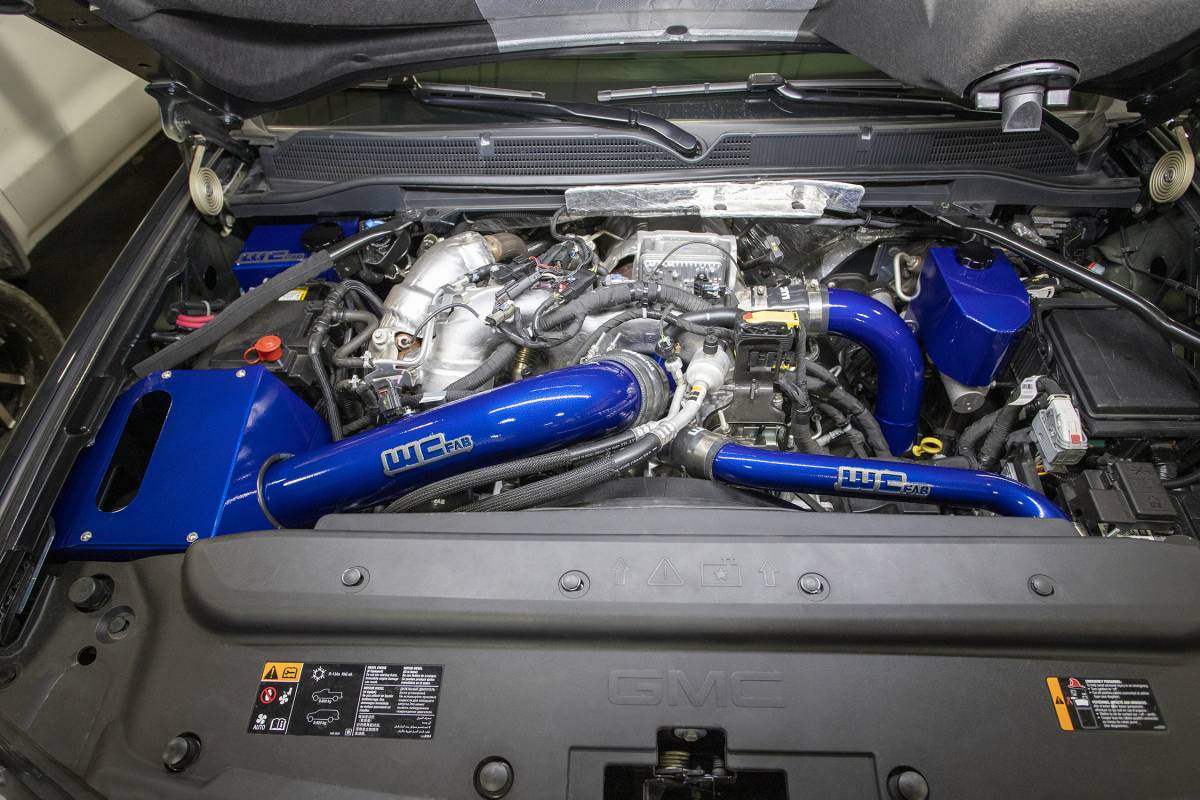 Wehrli WCF100344-RED 4 inch cold air intake kit with air box red L5P Duramax installed on truck in blue