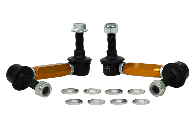 Set of suspension control arms with ball joints and spacers on a white background