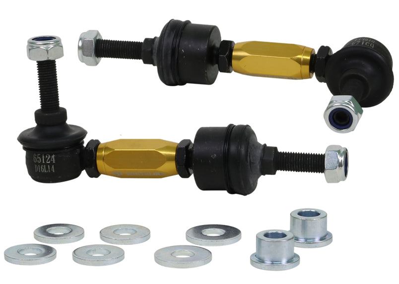 Set of automotive control arms with gold and black components on a white background