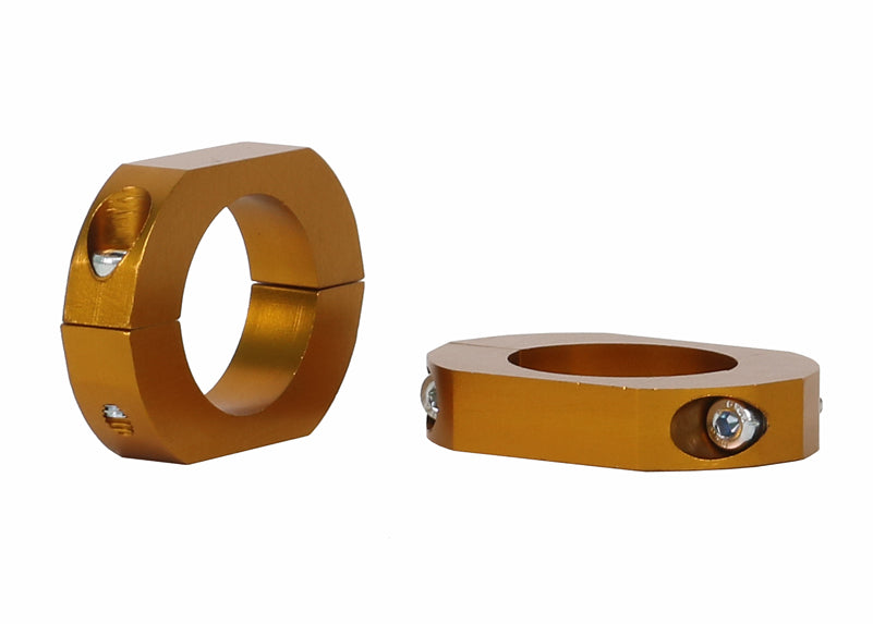 Two gold metal rings with screws on a white background