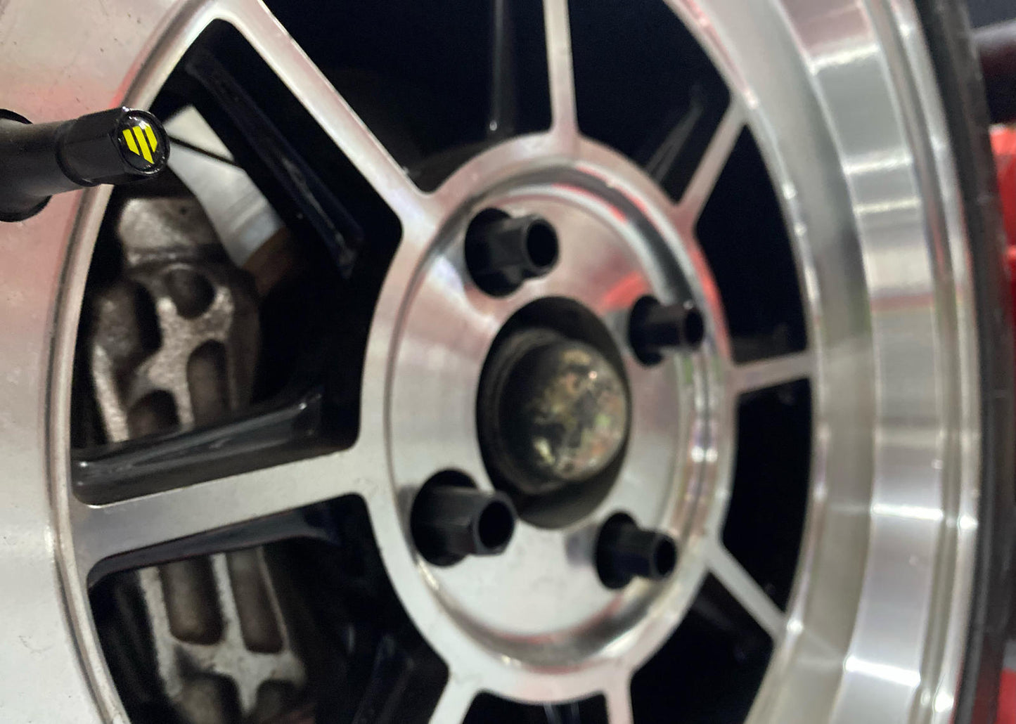 Close-up of a shiny car wheel rim with a black center.