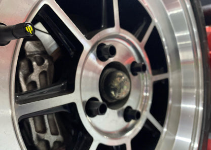 Close-up of a shiny car wheel rim with a black center.