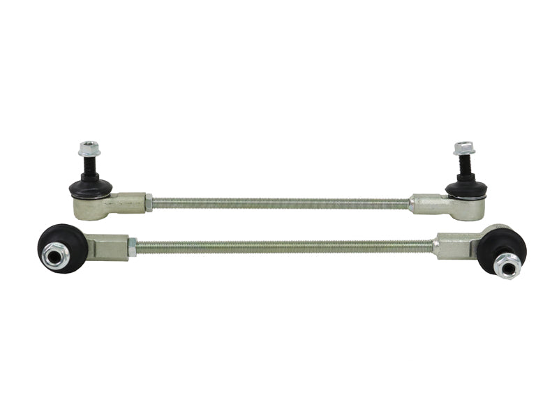 Two metal control arms with bearings on a white background