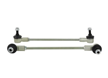 Two metal control arms with bearings on a white background