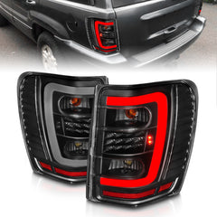 ANZO 1999-2004 Jeep Grand Cherokee LED Tail Lights w/ Light Bar Black Housing Clear Lens - eliteracefab.com